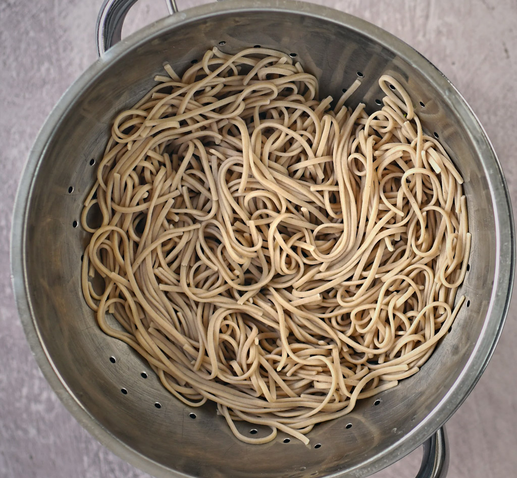 Draining the buckwheat noodles